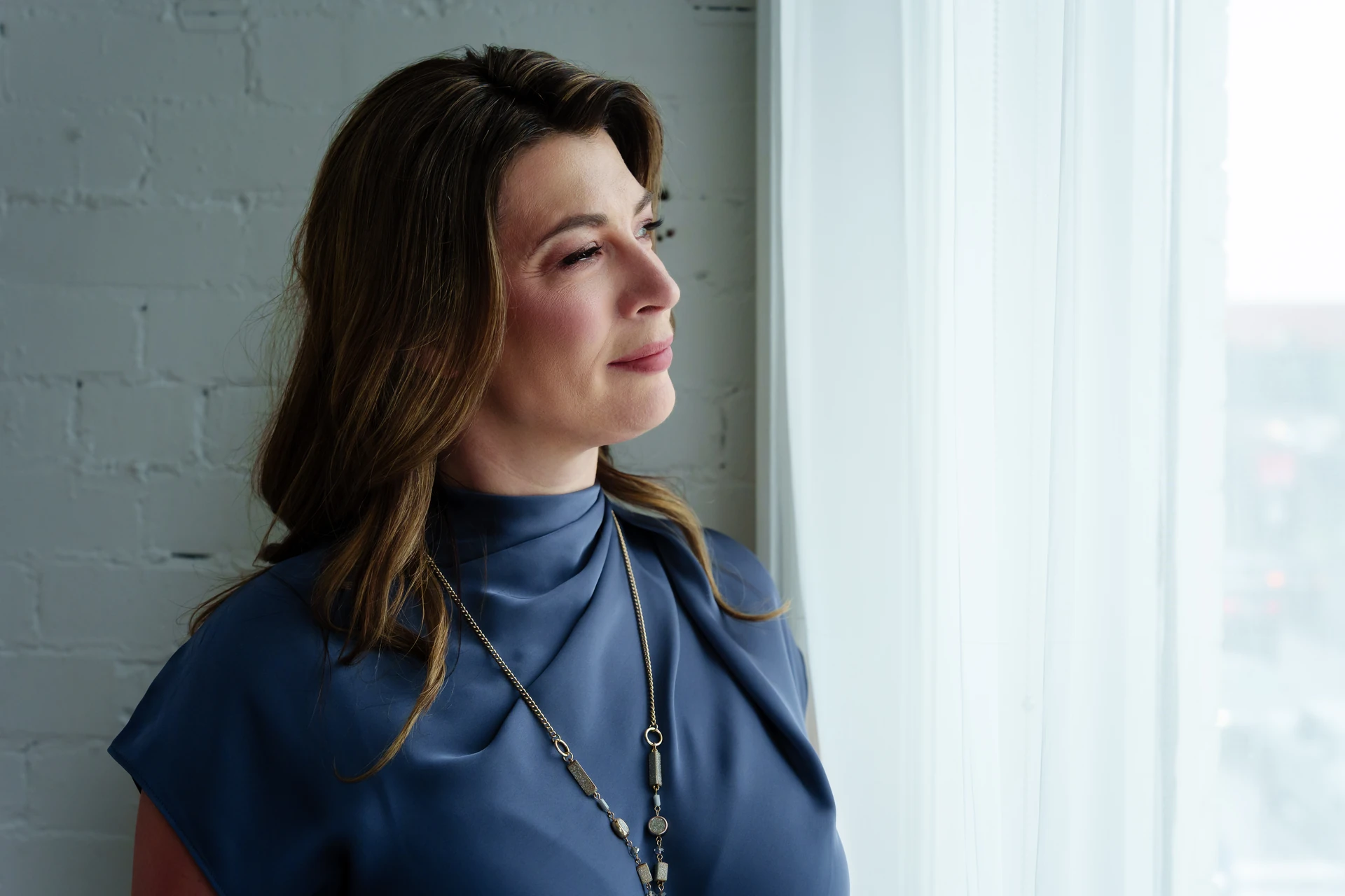 Wanda Chevrette, Registered Psychologist at reDiscover Couples Therapy, looking out a window